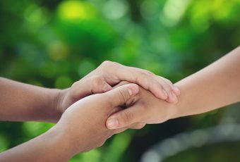 couple-holding-hands-green-meadow-1-1.jpg